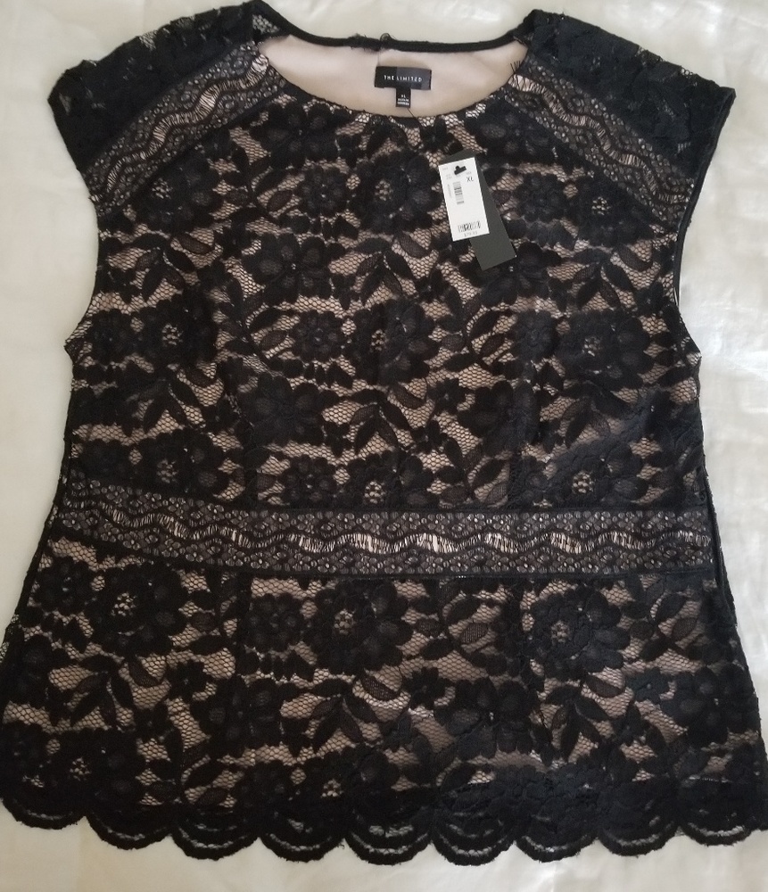 Black pattern veil on top of a skin tone blouse.
